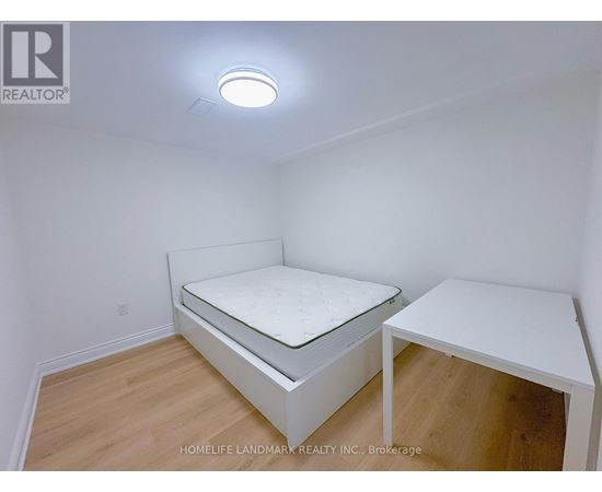 A bedroom with a bed and a desk.