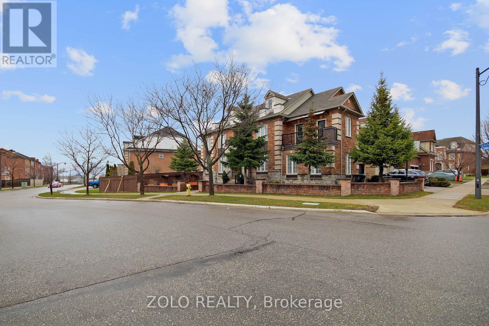 A real estate photo of a residential area with a house and trees.