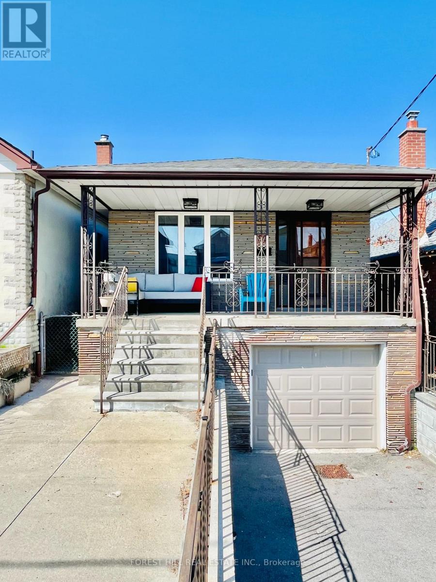 A house with a garage and a balcony.