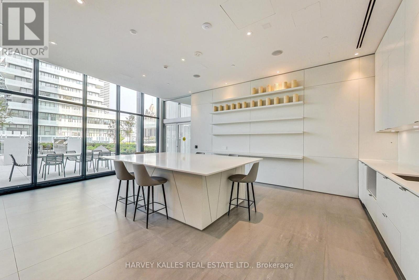 A modern kitchen with white cabinets and a central island.