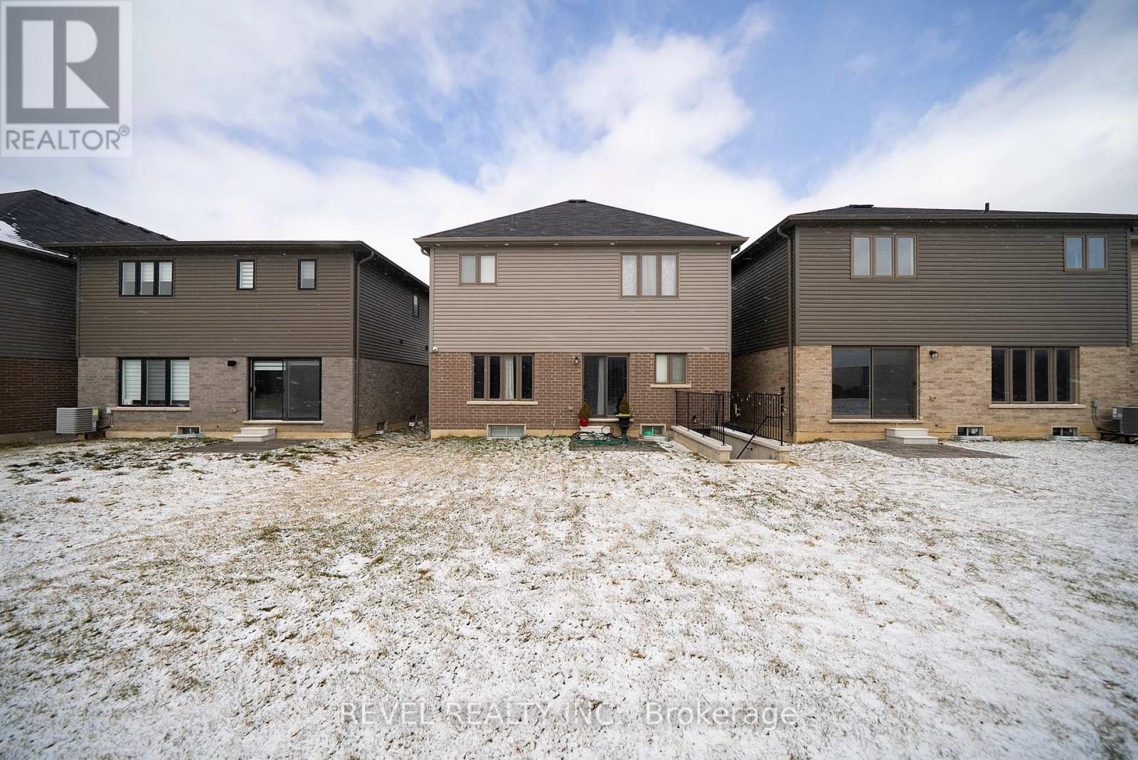 A realtor photo of a house with a snowy ground.