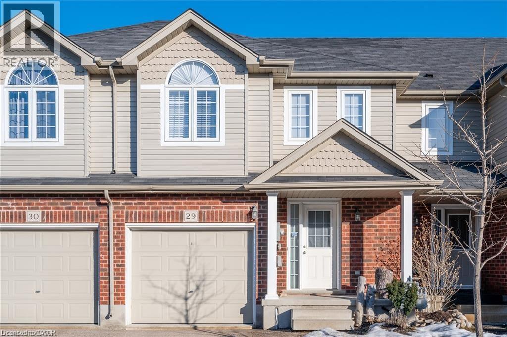 A two-story house with a garage on the ground floor.
