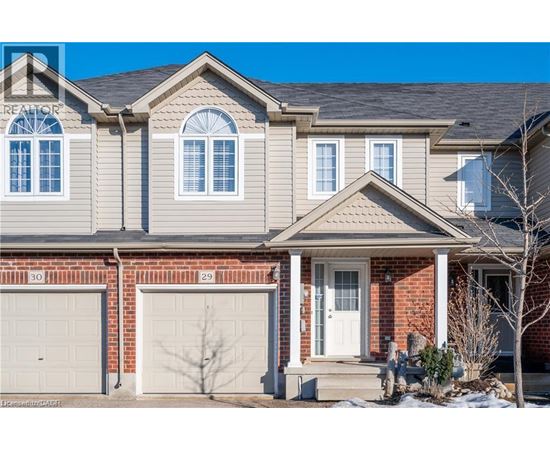 A two-story house with a garage on the ground floor.