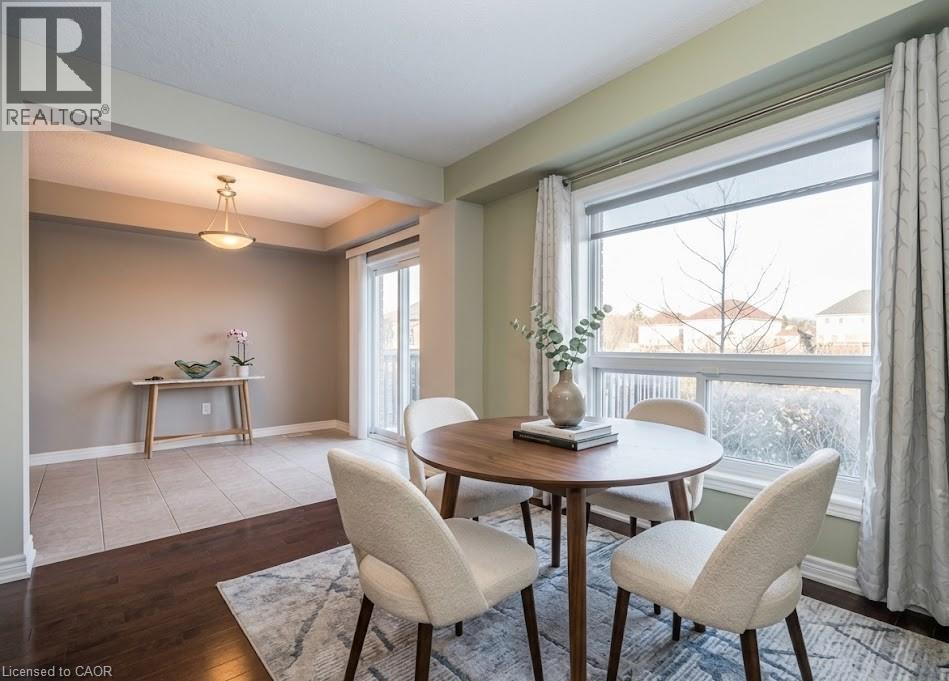 A dining room with a table and chairs.