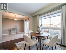 A dining room with a table and chairs.