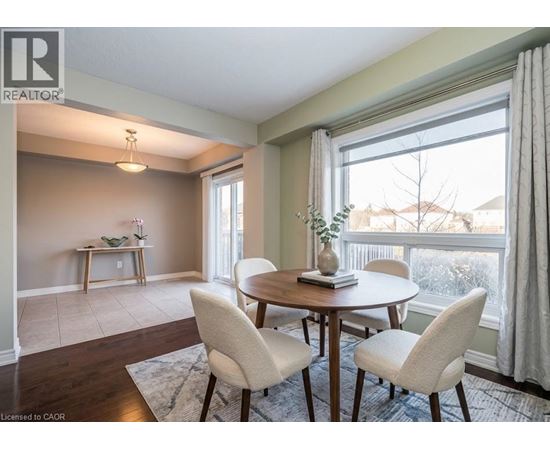 A dining room with a table and chairs.