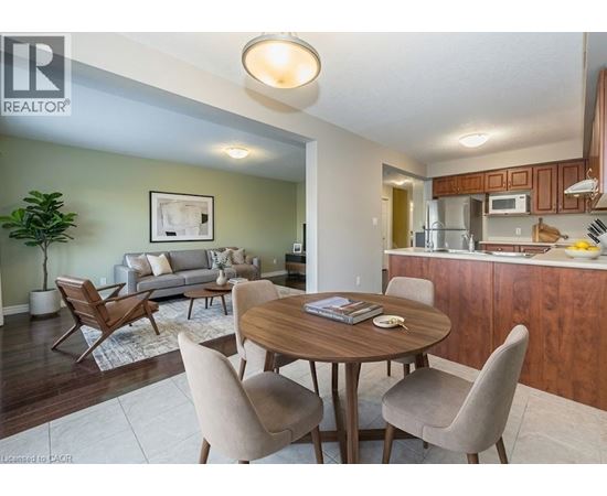 A living room with a dining table and chairs.