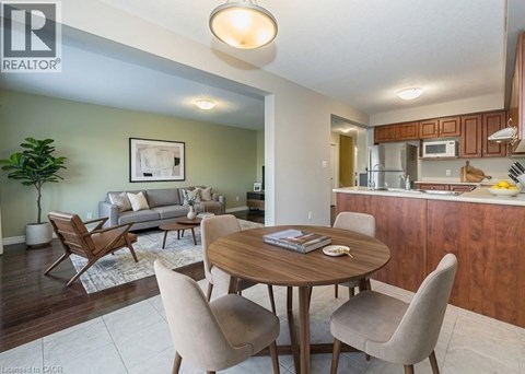 A living room with a dining table and chairs.