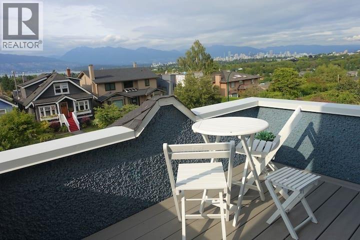 A poolside table with chairs overlooks a residential area.