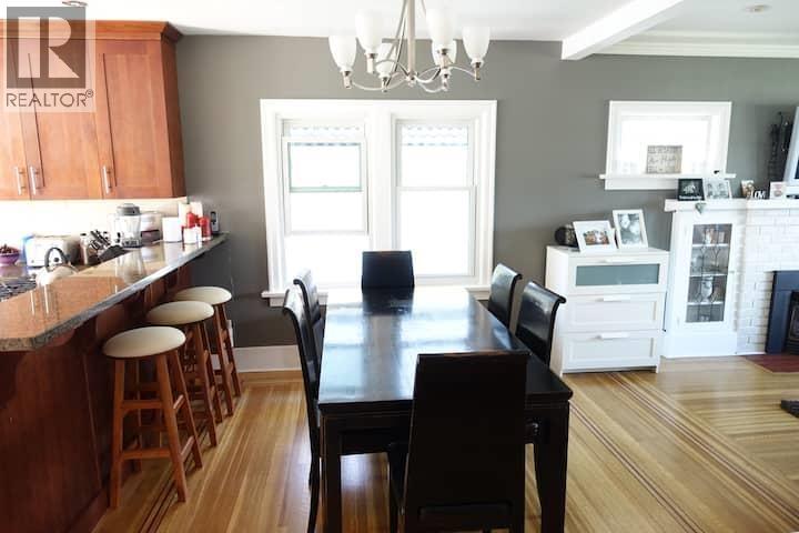 A kitchen with a table and chairs in the middle of the room.