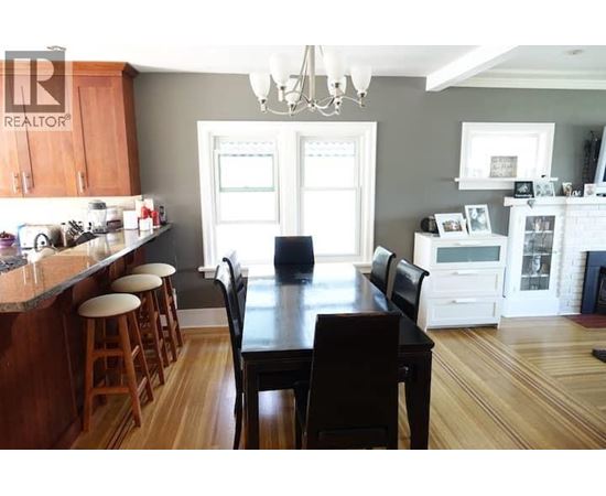 A kitchen with a table and chairs in the middle of the room.