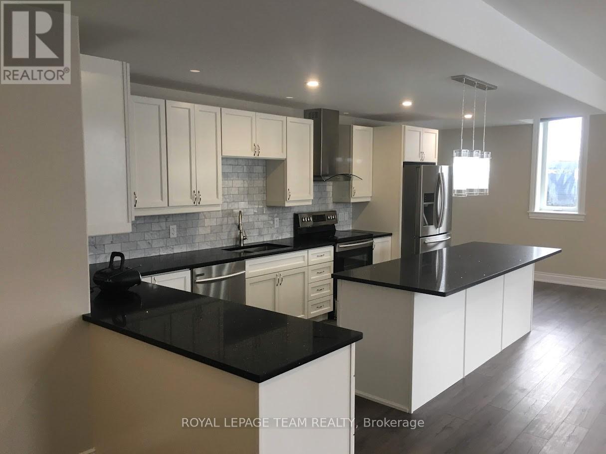 A kitchen with black countertops and white cabinets.