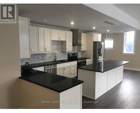 A kitchen with black countertops and white cabinets.