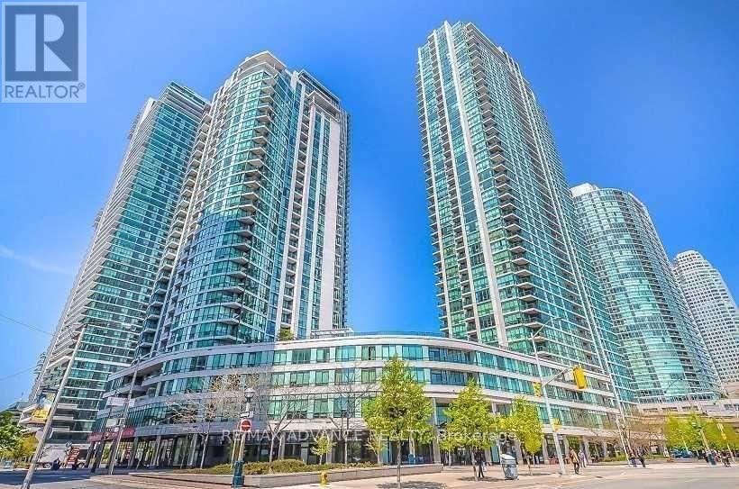 Two tall buildings with glass windows are situated in a city.