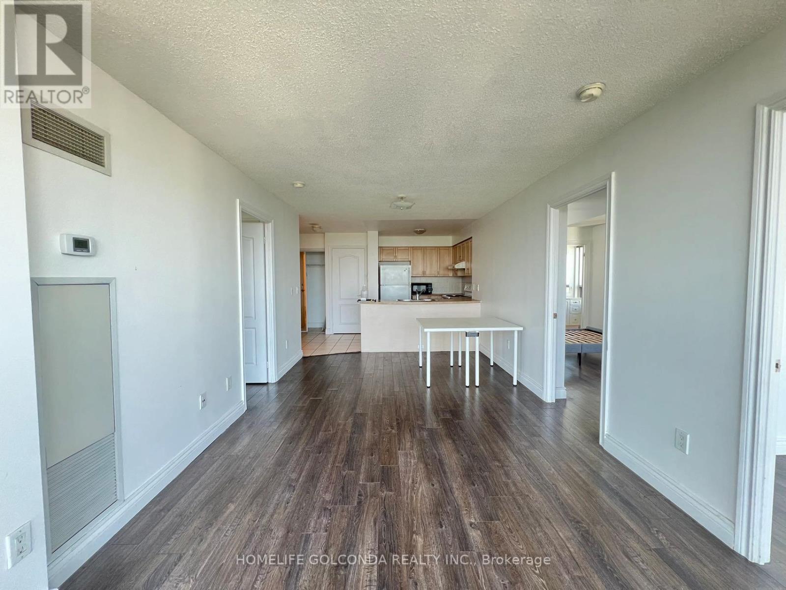A room with wooden floors and white walls.