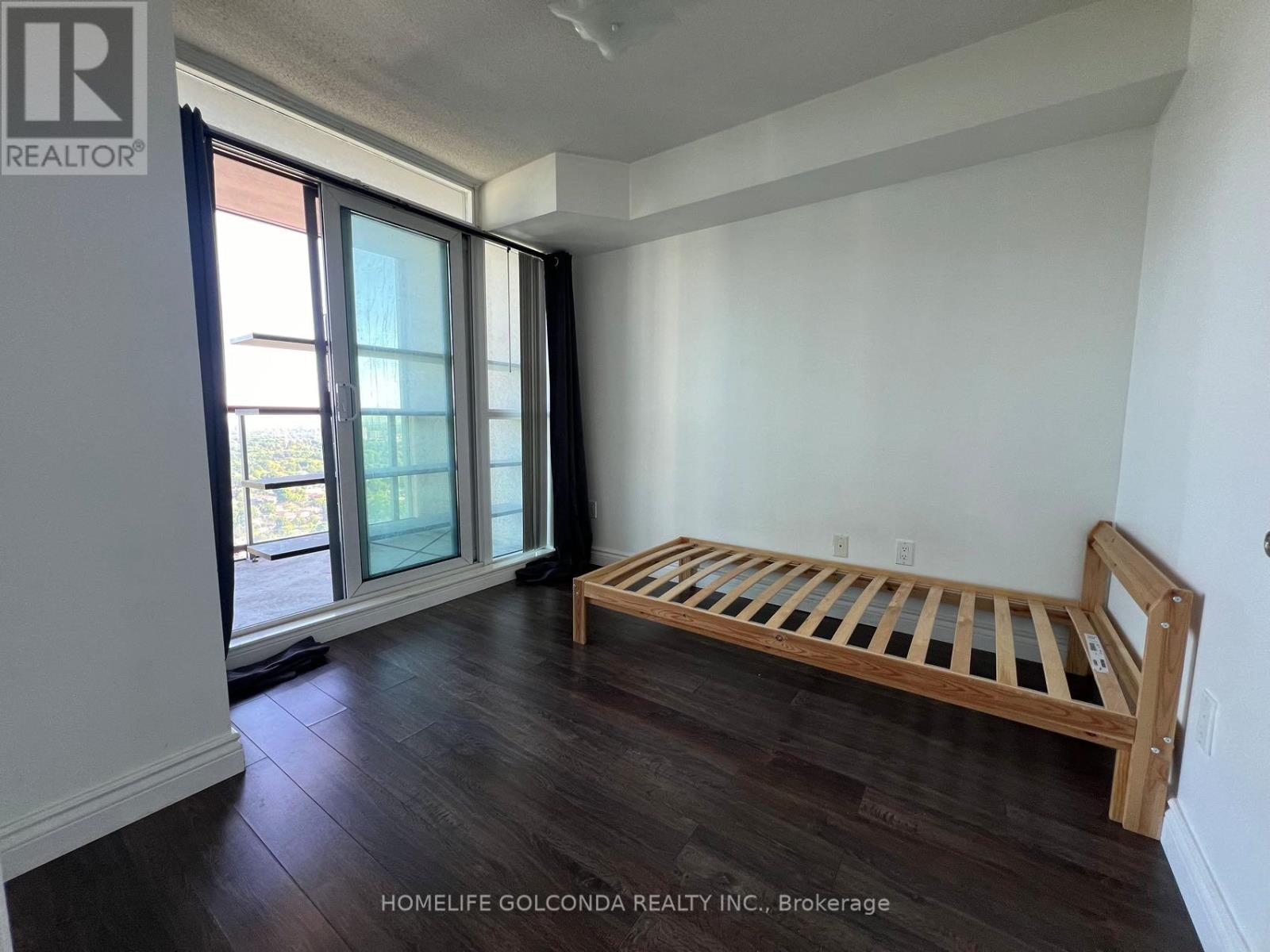 A bedroom with a bed and a window.