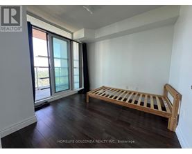 A bedroom with a bed and a window.