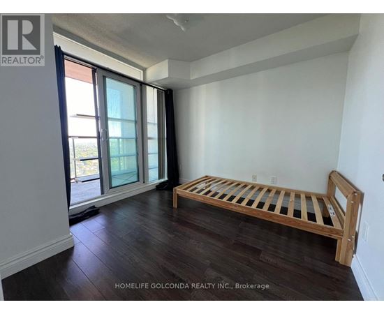 A bedroom with a bed and a window.