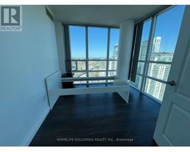 A room with a large window overlooking a cityscape.