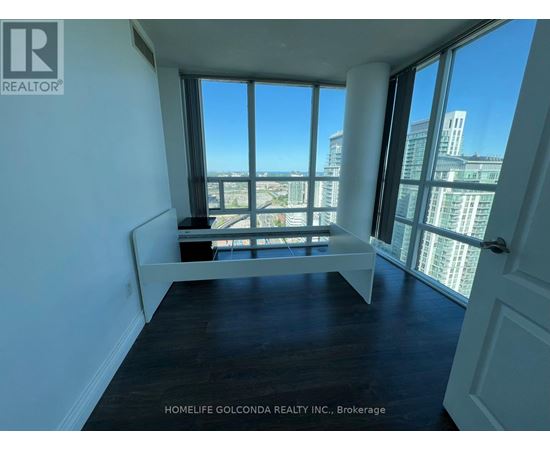 A room with a large window overlooking a cityscape.