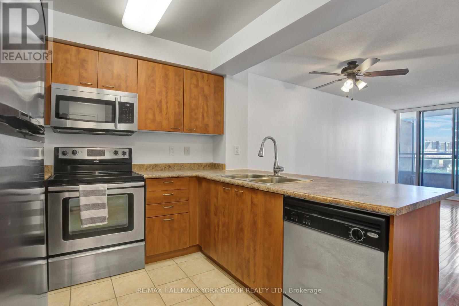 A kitchen with wooden cabinets and stainless steel appliances.