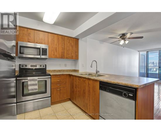 A kitchen with wooden cabinets and stainless steel appliances.