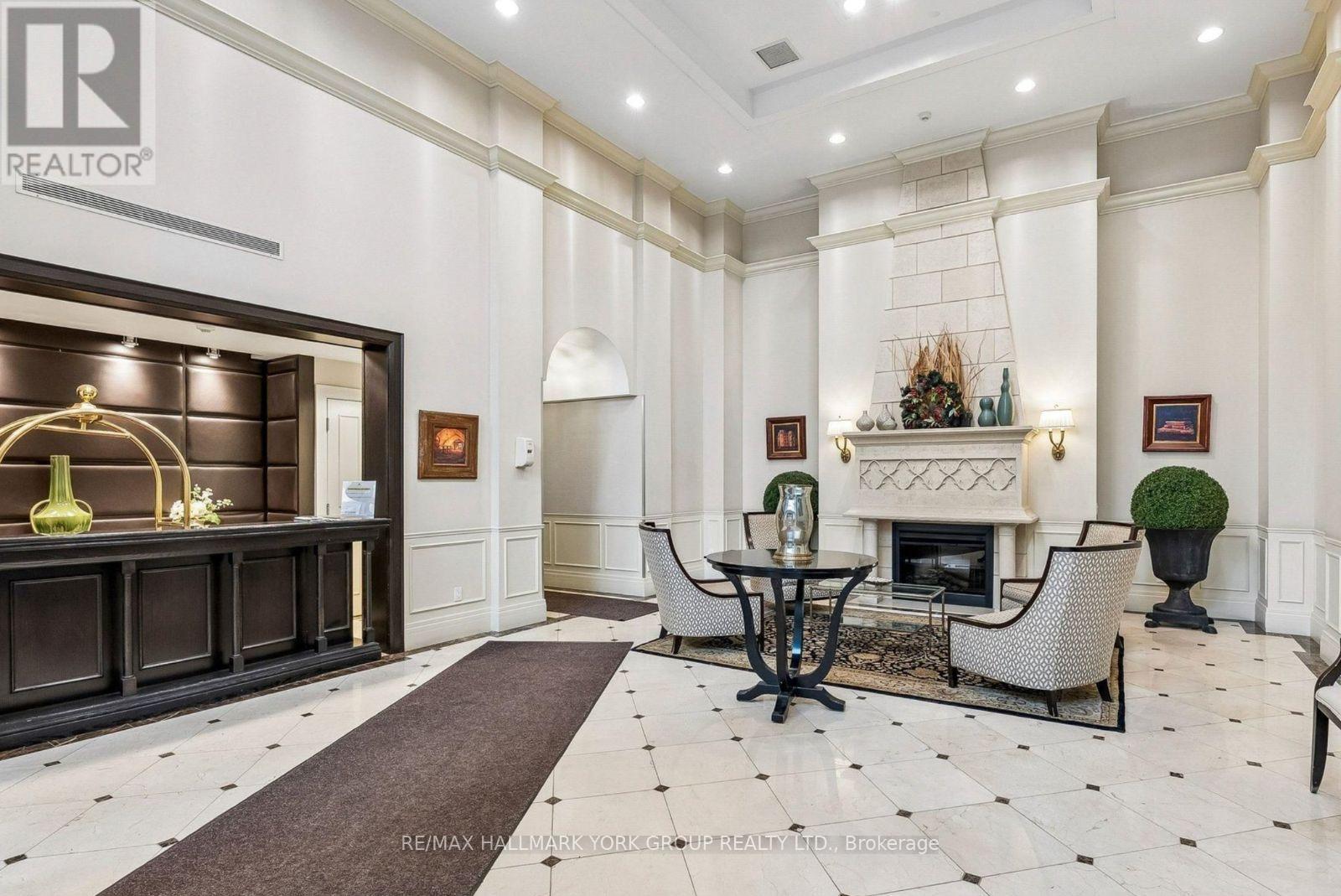 A well-lit, elegant living room with a fireplace and a dining table set up.