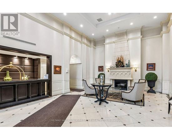 A well-lit, elegant living room with a fireplace and a dining table set up.