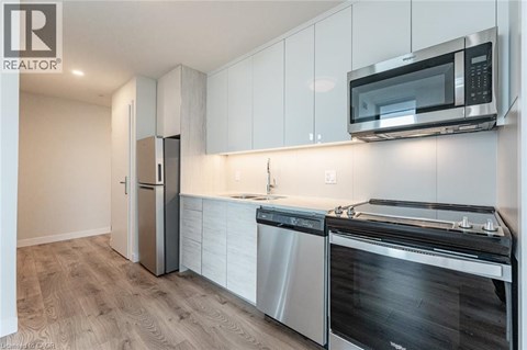 A modern kitchen with a stainless steel dishwasher and microwave.