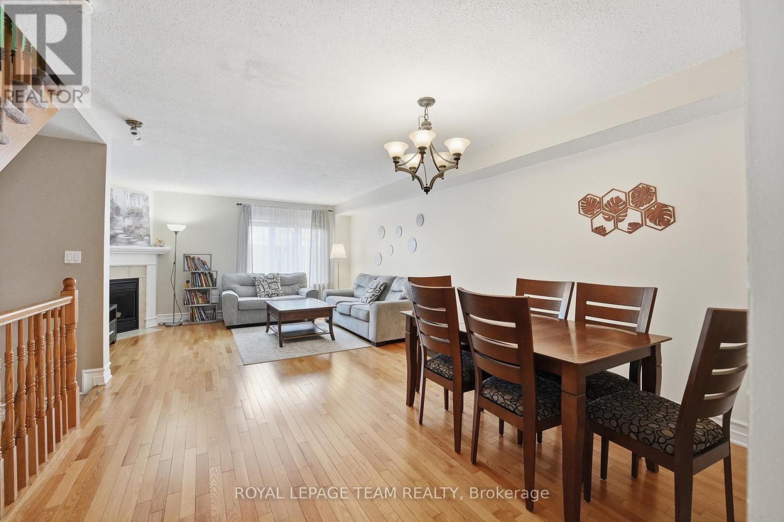 A dining room with a wooden table and chairs.