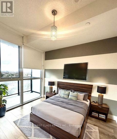 A bedroom with a large bed and a flat screen TV mounted on the wall.