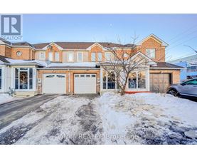 A house with a red brick facade and a white garage door is for sale.
