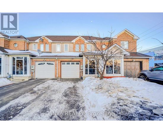 A house with a red brick facade and a white garage door is for sale.