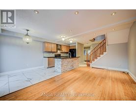 A spacious room with wooden floors and a marble countertop.