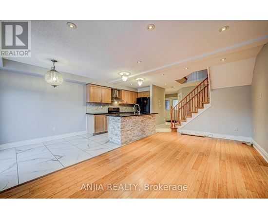 A spacious room with wooden floors and a marble countertop.
