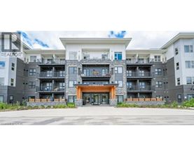 A large apartment complex with a central entrance and balconies on the upper floors.