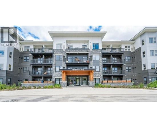 A large apartment complex with a central entrance and balconies on the upper floors.