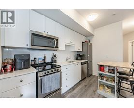 A kitchen with white cabinets and a microwave above the stove.