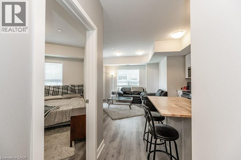 A well-lit, modern bedroom with a large bed and a separate sitting area with a couch and a coffee table.