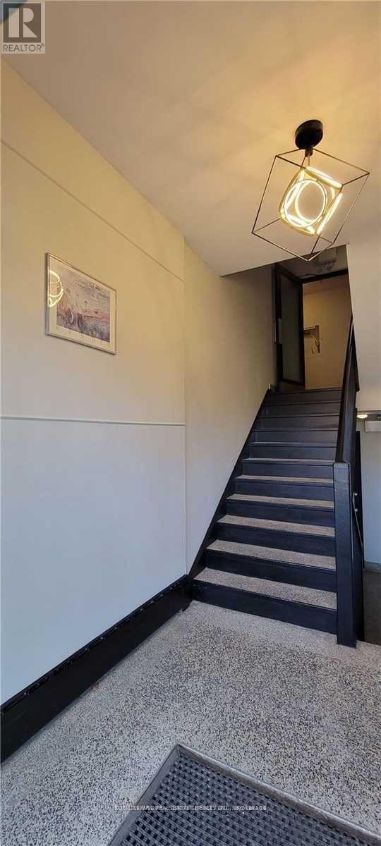 A staircase with a light hanging from the ceiling.