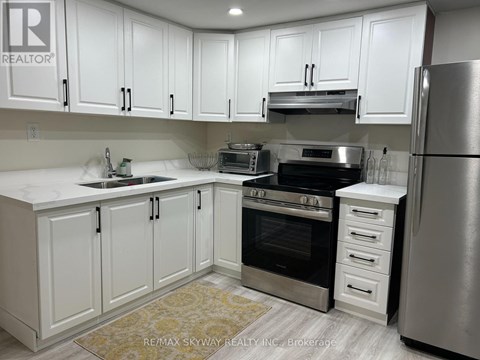 A kitchen with white cabinets and stainless steel appliances.