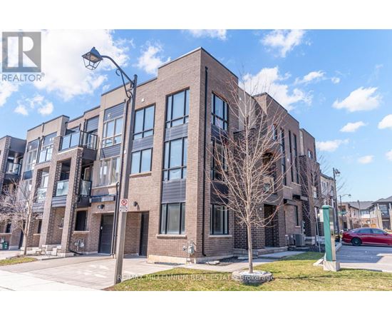 A modern brick building with a sign that reads "RE/MAX Millennium Real Estate" in front of it.