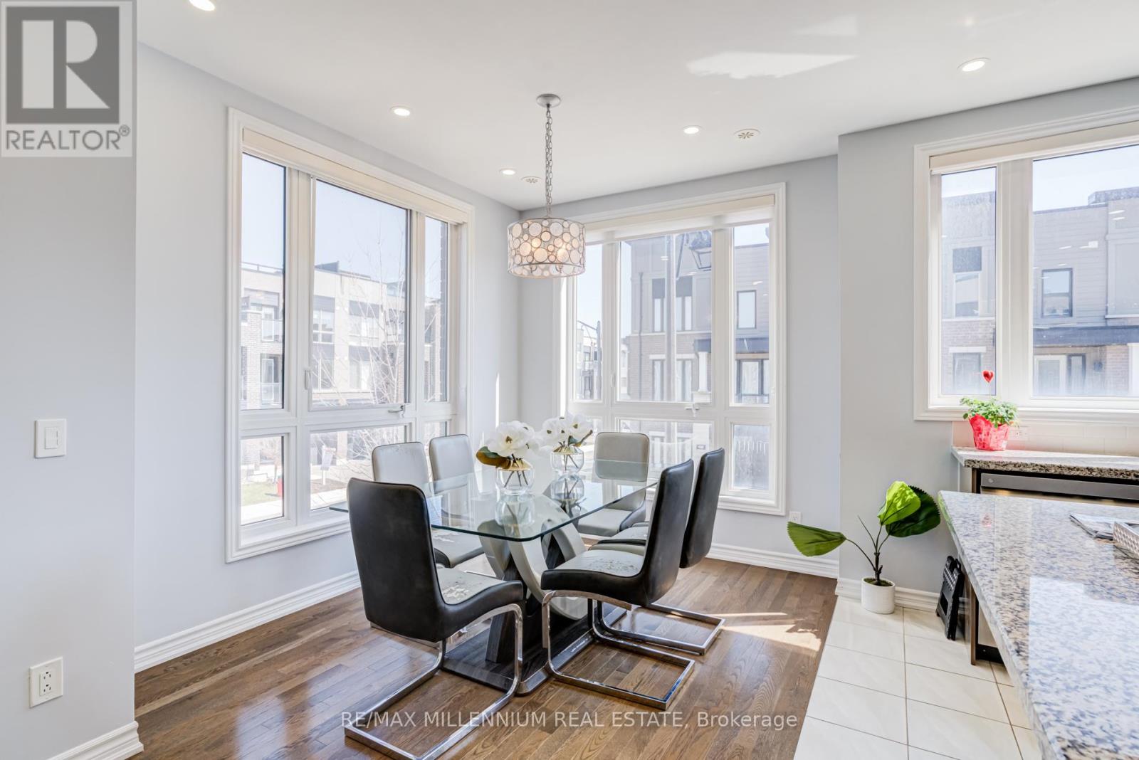 A dining room with a glass table and chairs.