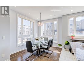 A dining room with a glass table and chairs.