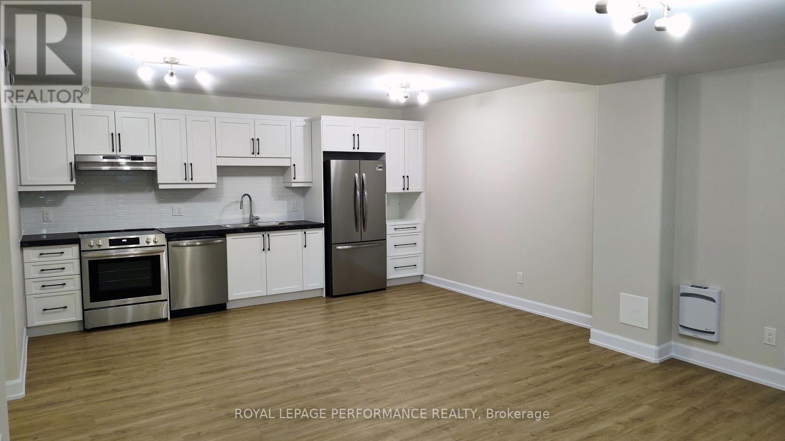 A kitchen with white cabinets and stainless steel appliances.