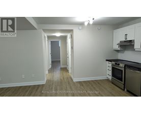 A kitchen area with a stove top oven and microwave.