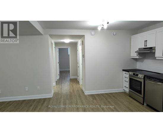 A kitchen area with a stove top oven and microwave.