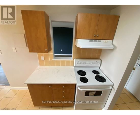 A kitchen with a stove and cabinets.