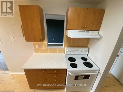 A kitchen with a stove and cabinets.