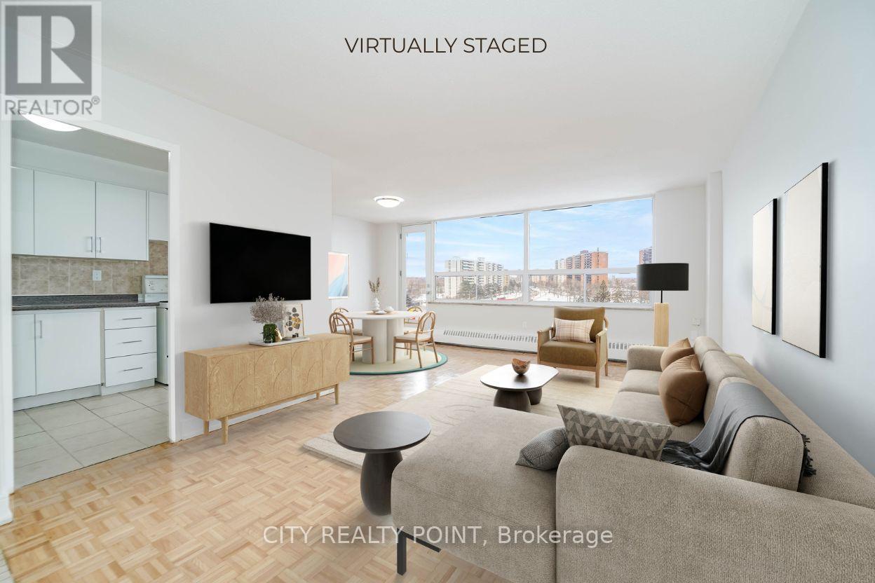 A living room with a couch, a coffee table, and a television.